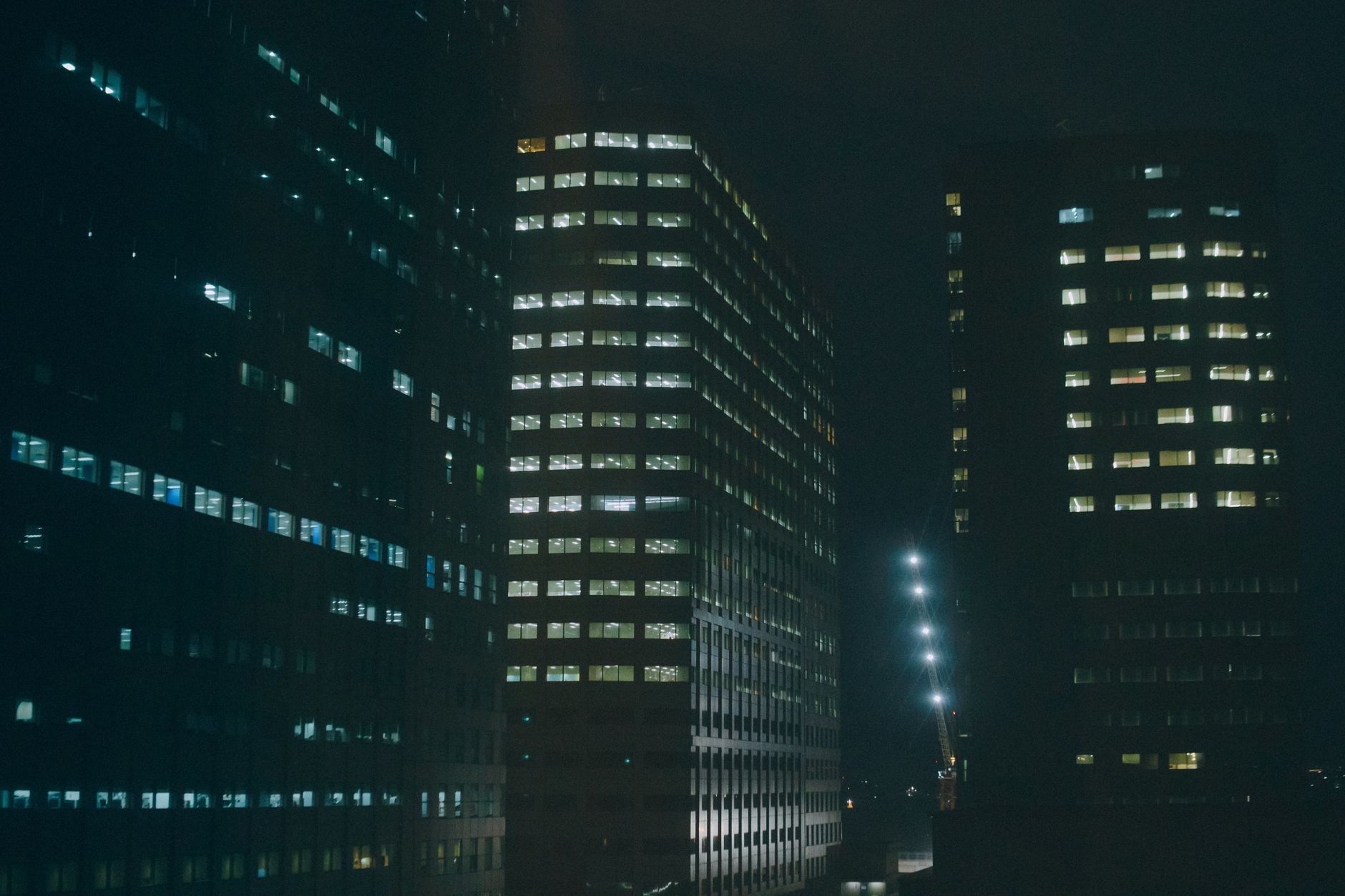 Office towers at night with lit floors